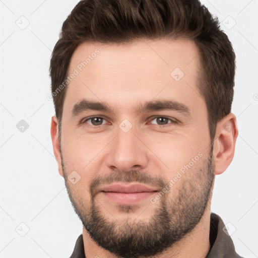 Joyful white young-adult male with short  brown hair and brown eyes