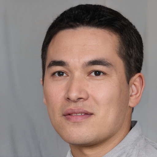 Joyful white young-adult male with short  black hair and brown eyes
