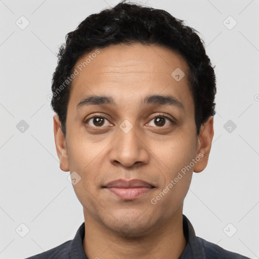 Joyful latino young-adult male with short  black hair and brown eyes