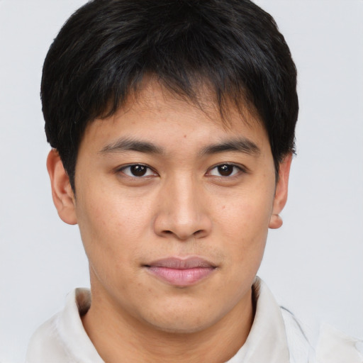 Joyful asian young-adult male with short  brown hair and brown eyes