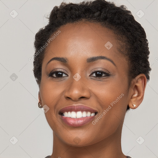 Joyful black young-adult female with short  brown hair and brown eyes