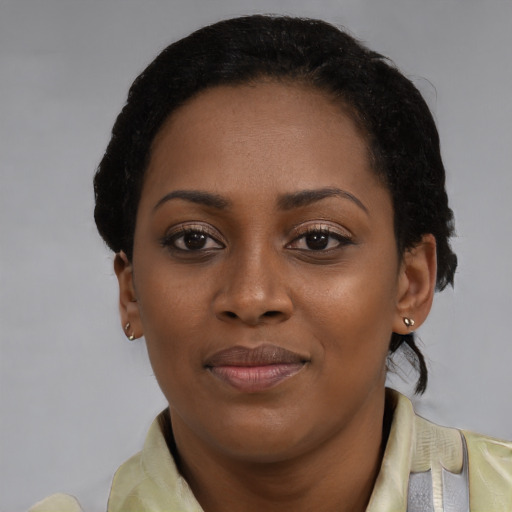 Joyful black young-adult female with short  brown hair and brown eyes