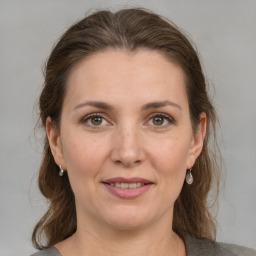 Joyful white adult female with medium  brown hair and grey eyes