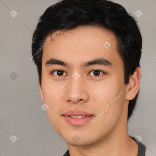 Joyful asian young-adult male with short  black hair and brown eyes