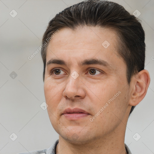 Joyful white adult male with short  brown hair and brown eyes