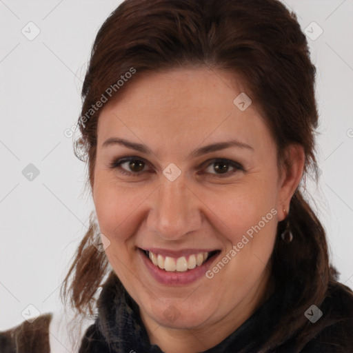 Joyful white adult female with medium  brown hair and brown eyes