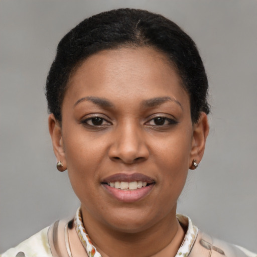 Joyful black young-adult female with short  brown hair and brown eyes