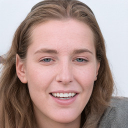 Joyful white young-adult female with long  brown hair and blue eyes