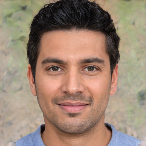 Joyful white young-adult male with short  black hair and brown eyes