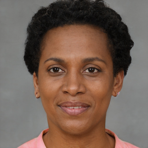 Joyful black adult female with short  brown hair and brown eyes