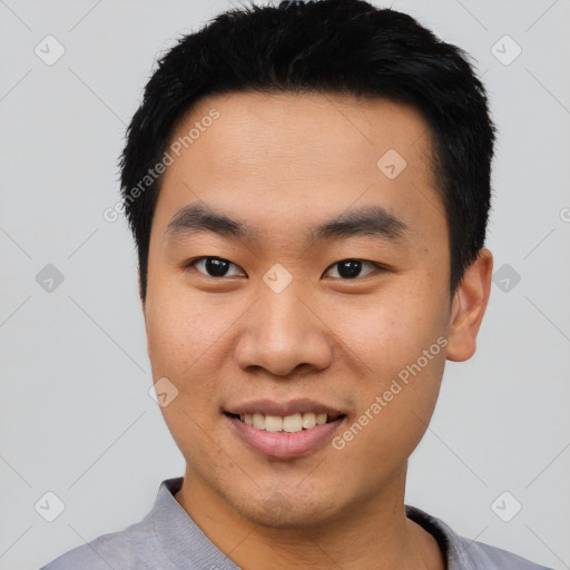 Joyful asian young-adult male with short  black hair and brown eyes