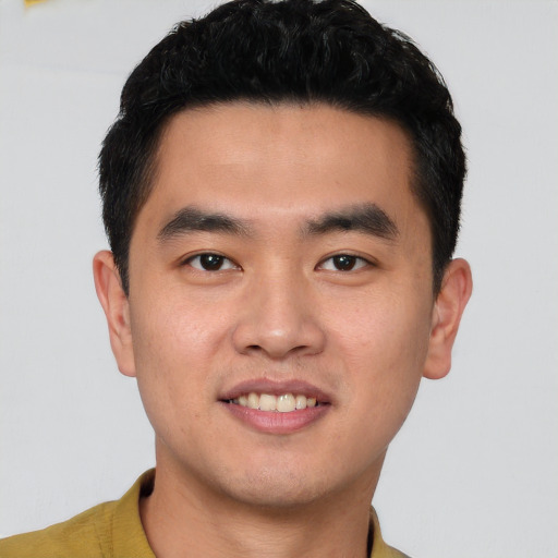 Joyful latino young-adult male with short  black hair and brown eyes
