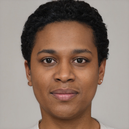 Joyful black young-adult female with short  black hair and brown eyes