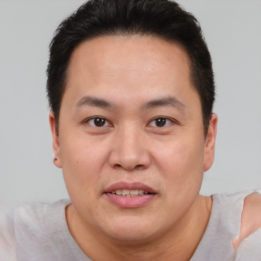 Joyful white adult male with short  brown hair and brown eyes