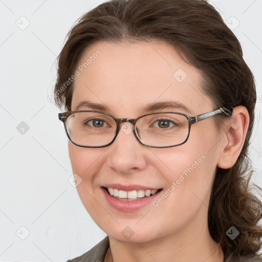 Joyful white young-adult female with medium  brown hair and grey eyes