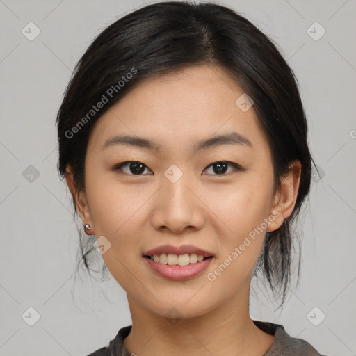 Joyful asian young-adult female with medium  black hair and brown eyes