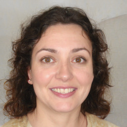 Joyful white adult female with medium  brown hair and brown eyes