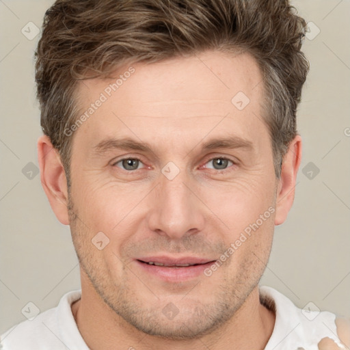 Joyful white adult male with short  brown hair and grey eyes