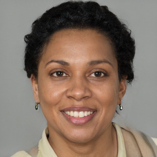 Joyful latino adult female with short  brown hair and brown eyes