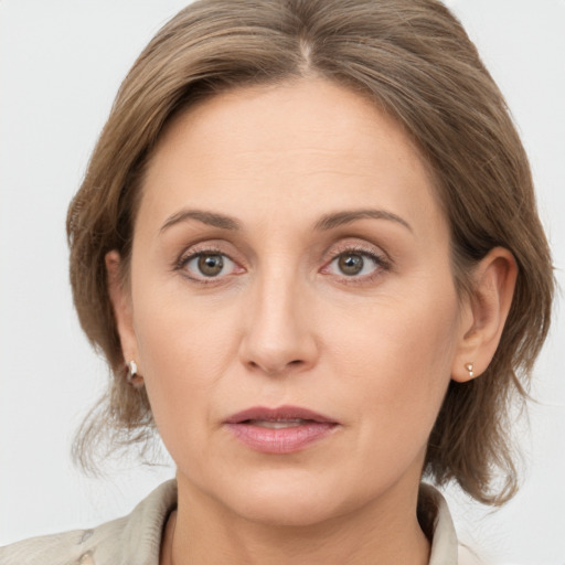 Joyful white adult female with medium  brown hair and grey eyes