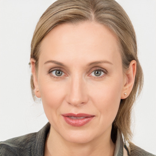 Joyful white adult female with medium  brown hair and blue eyes