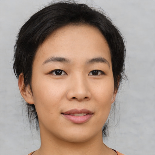 Joyful asian young-adult female with medium  brown hair and brown eyes