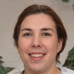 Joyful white adult female with medium  brown hair and brown eyes