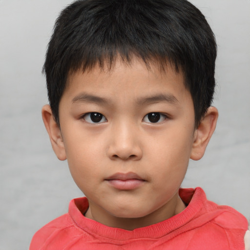 Neutral asian child male with short  brown hair and brown eyes