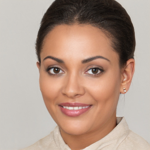 Joyful latino young-adult female with short  brown hair and brown eyes