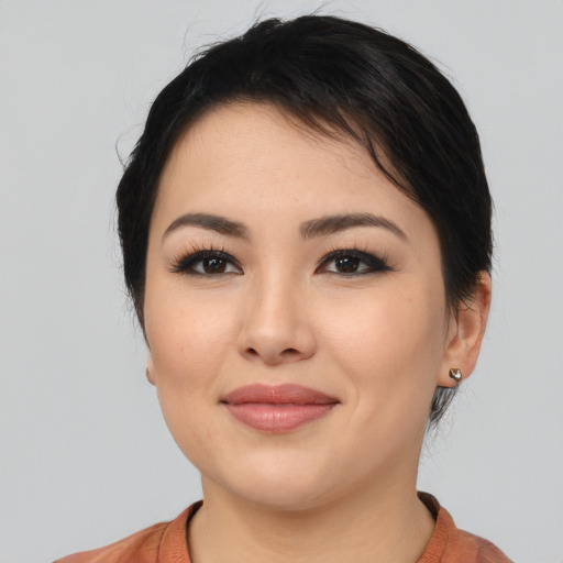 Joyful latino young-adult female with medium  black hair and brown eyes