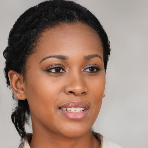 Joyful black young-adult female with medium  black hair and brown eyes