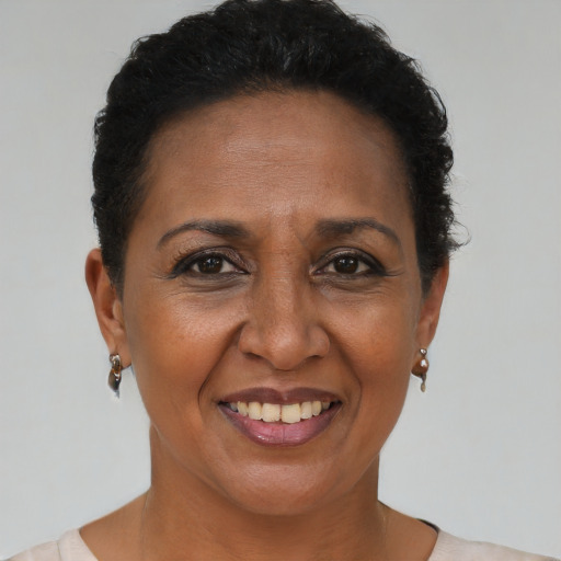 Joyful black adult female with short  brown hair and brown eyes