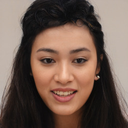 Joyful asian young-adult female with long  brown hair and brown eyes