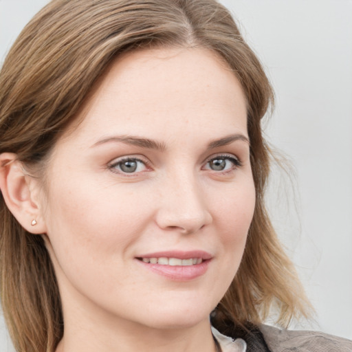 Joyful white young-adult female with medium  brown hair and blue eyes