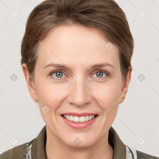 Joyful white adult female with short  brown hair and grey eyes