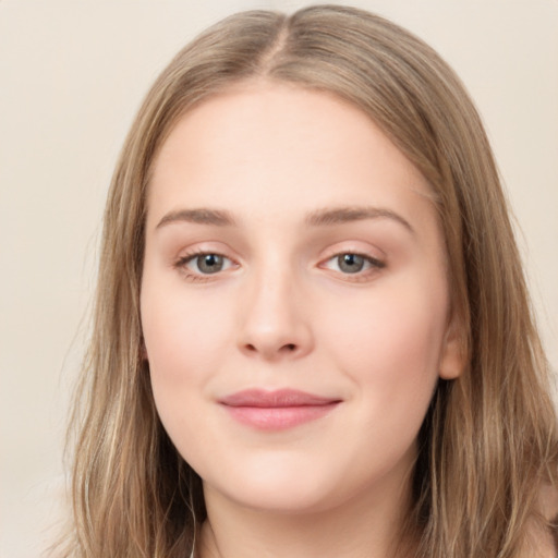 Joyful white young-adult female with long  brown hair and green eyes