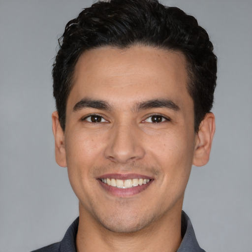 Joyful white young-adult male with short  black hair and brown eyes