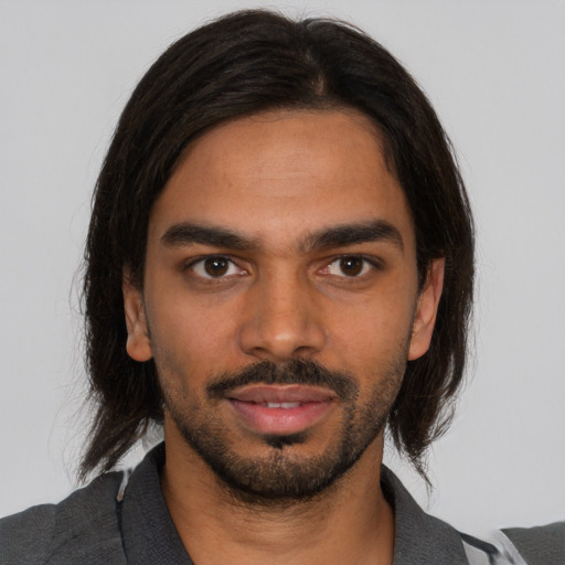 Joyful black young-adult male with medium  brown hair and brown eyes