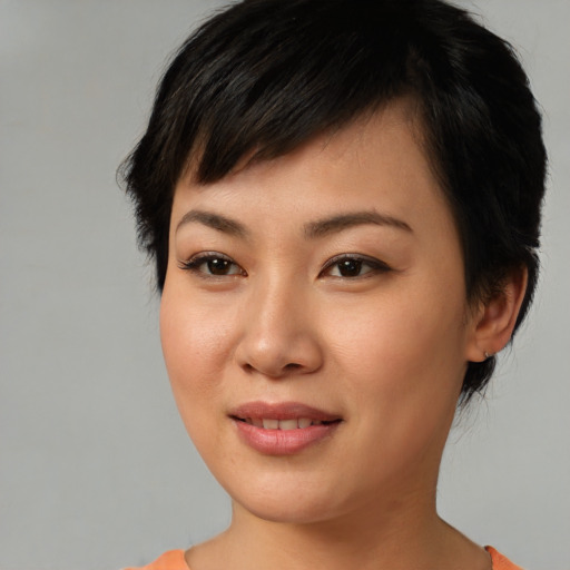 Joyful asian young-adult female with short  brown hair and brown eyes
