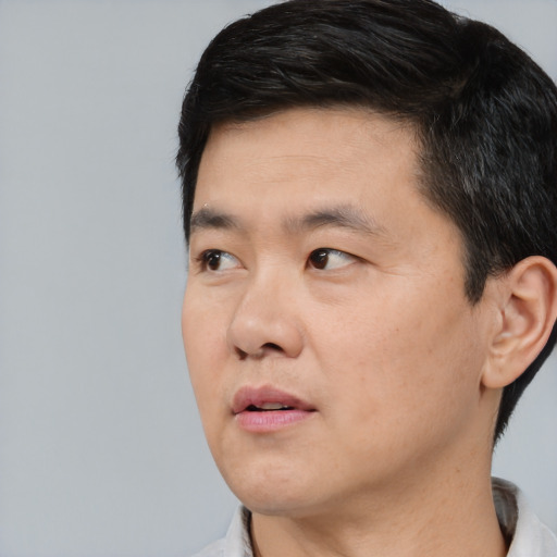 Neutral asian young-adult male with short  black hair and brown eyes