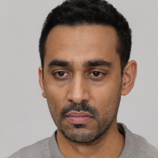 Neutral black young-adult male with short  black hair and brown eyes