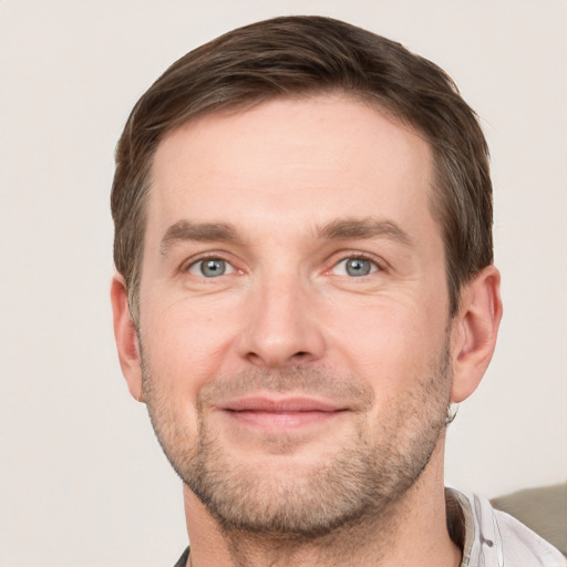 Joyful white adult male with short  brown hair and grey eyes