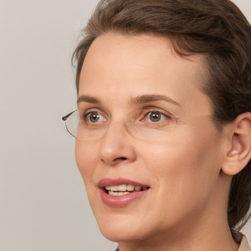 Joyful white adult female with medium  brown hair and grey eyes