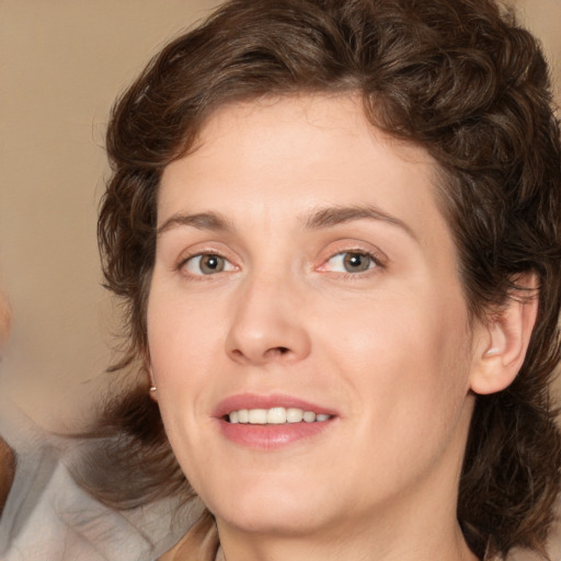 Joyful white young-adult female with medium  brown hair and green eyes