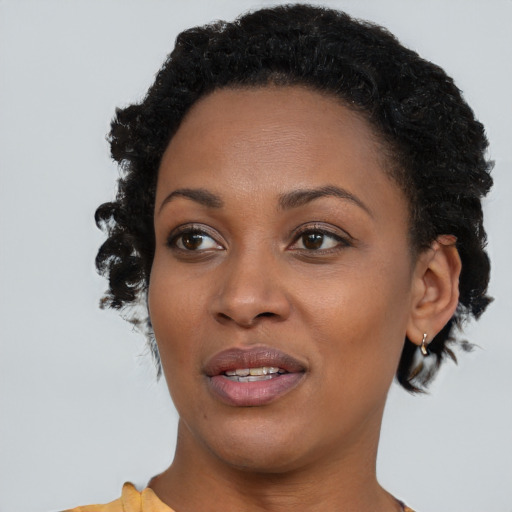 Joyful black young-adult female with short  brown hair and brown eyes