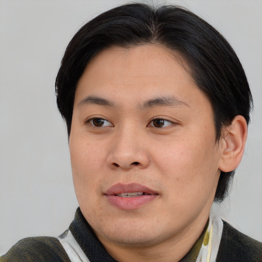 Joyful asian young-adult male with short  brown hair and brown eyes