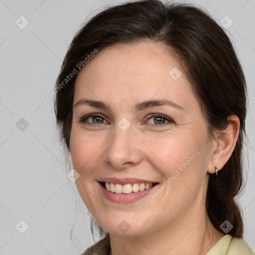 Joyful white adult female with medium  brown hair and brown eyes