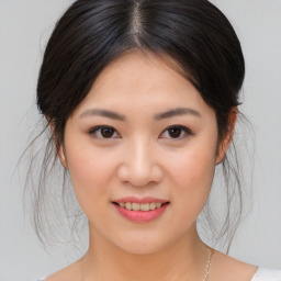 Joyful asian young-adult female with medium  brown hair and brown eyes