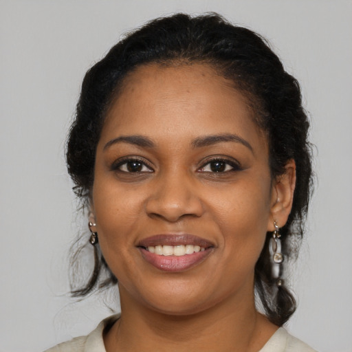 Joyful black young-adult female with medium  brown hair and brown eyes