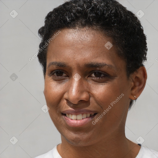 Joyful black adult female with short  brown hair and brown eyes